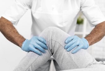 male-physiotherapist-checking-woman-s-knee-mobility-min
